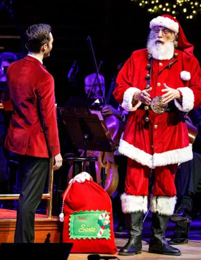 Enrico Lopez-Yañez with Santa Claus onstage at the Kimmel Center