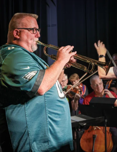 Trumpet player wearing an Eagles jersey - Bachrach Photography